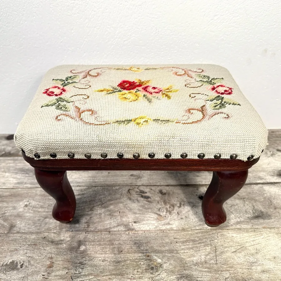 1960s Swedish handmade needlepoint floral footstool with solid wood frame, front view showing vibrant embroidered blooms