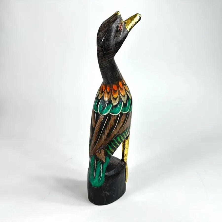 Back view of wooden duck figurine displaying carved back contours and comprehensive hand-painted surface treatment