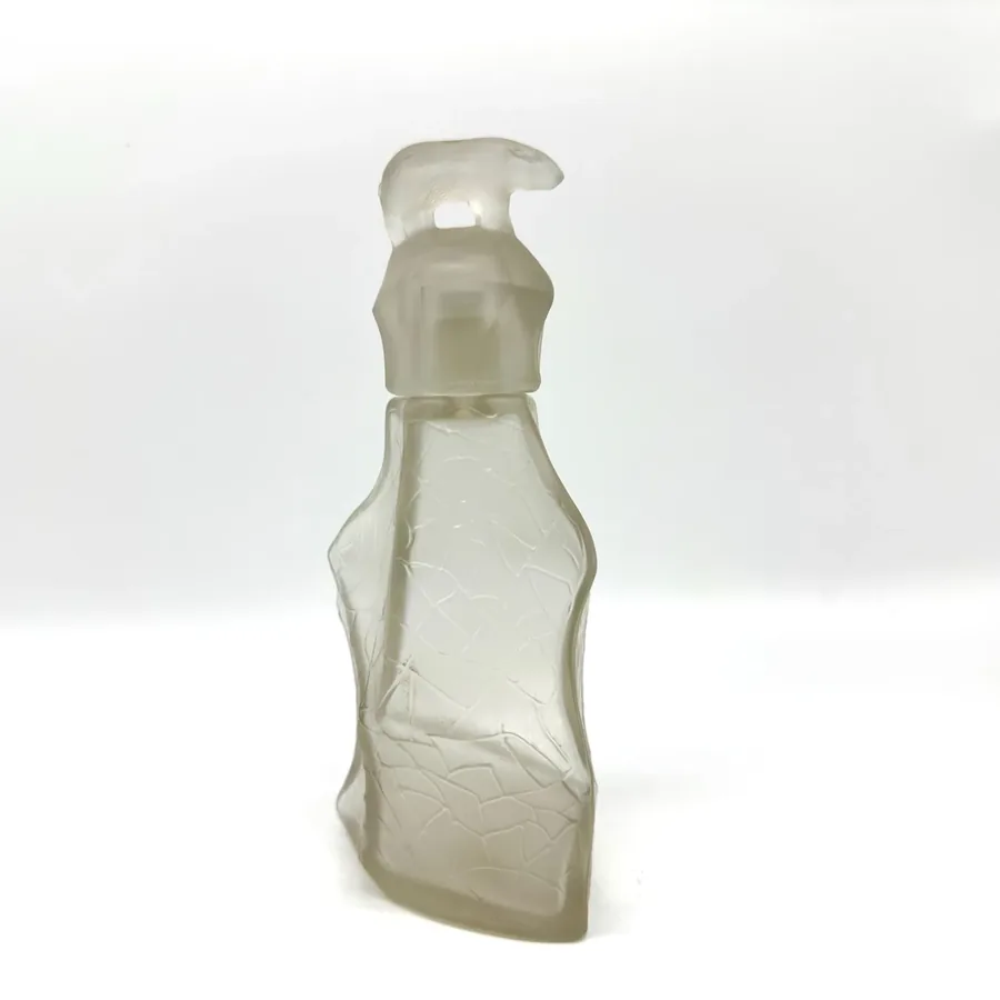 Backlit view of TeZHe frosted craquelé glass perfume bottle showing light transmission and interior glass clarity through the