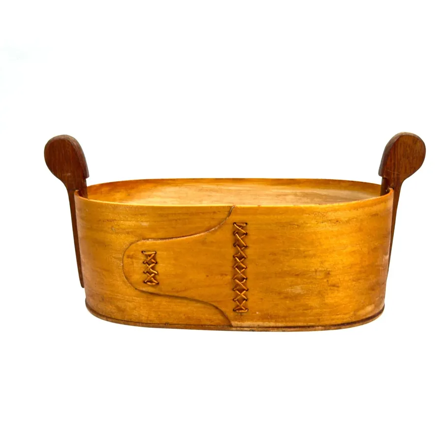 Bentwood box interior view showing golden wood construction, hand-stitched seams, and storage capacity