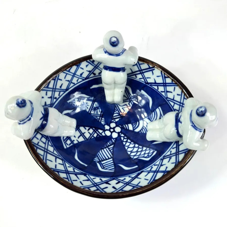 Bottom view of Japanese Sumida Gawa bowl showing base marking, unglazed foot, and maker identification