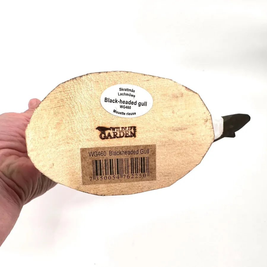 Bottom view of wooden seagull base showing maker's mark, stamp details, and hand-carved wood foundation