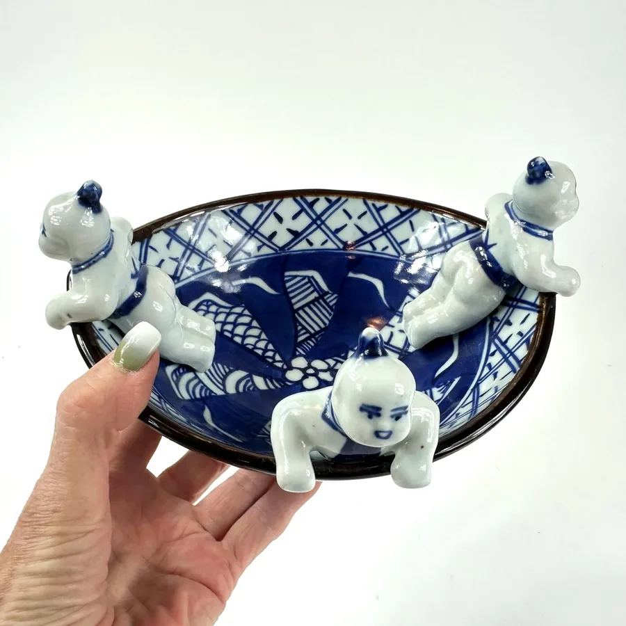 Close-up of hand-painted Japanese blue decoration showing brushstroke technique and cobalt pigment variations