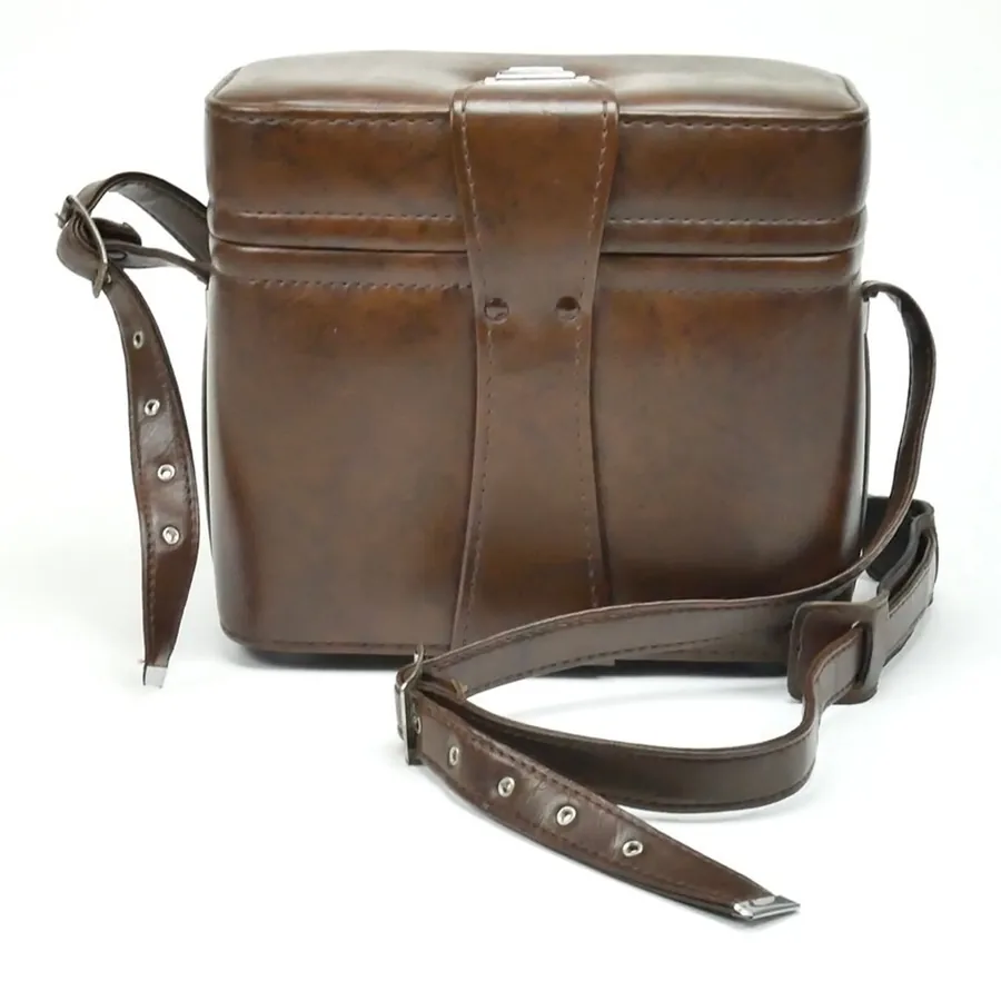 Complete 1970s brown leather camera bag with dual shoulder straps displayed in neutral studio lighting