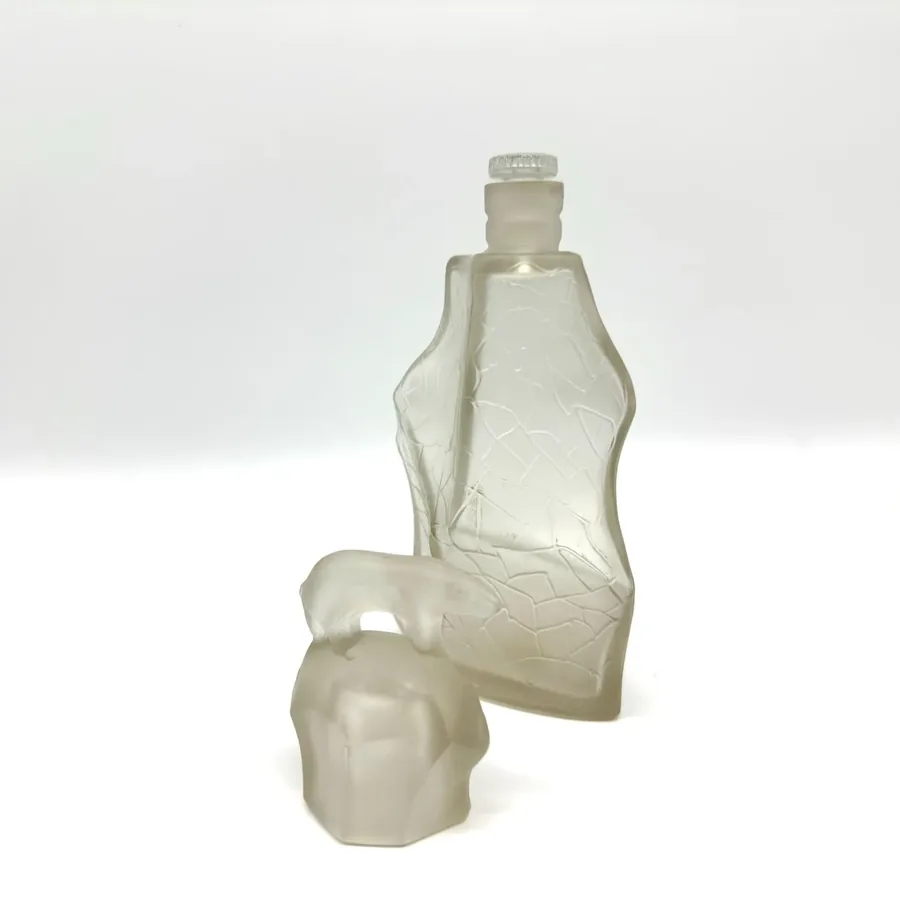 Complete still-life composition of TeZHe polar bear perfume bottle displayed at angle showing overall condition, frosted glas
