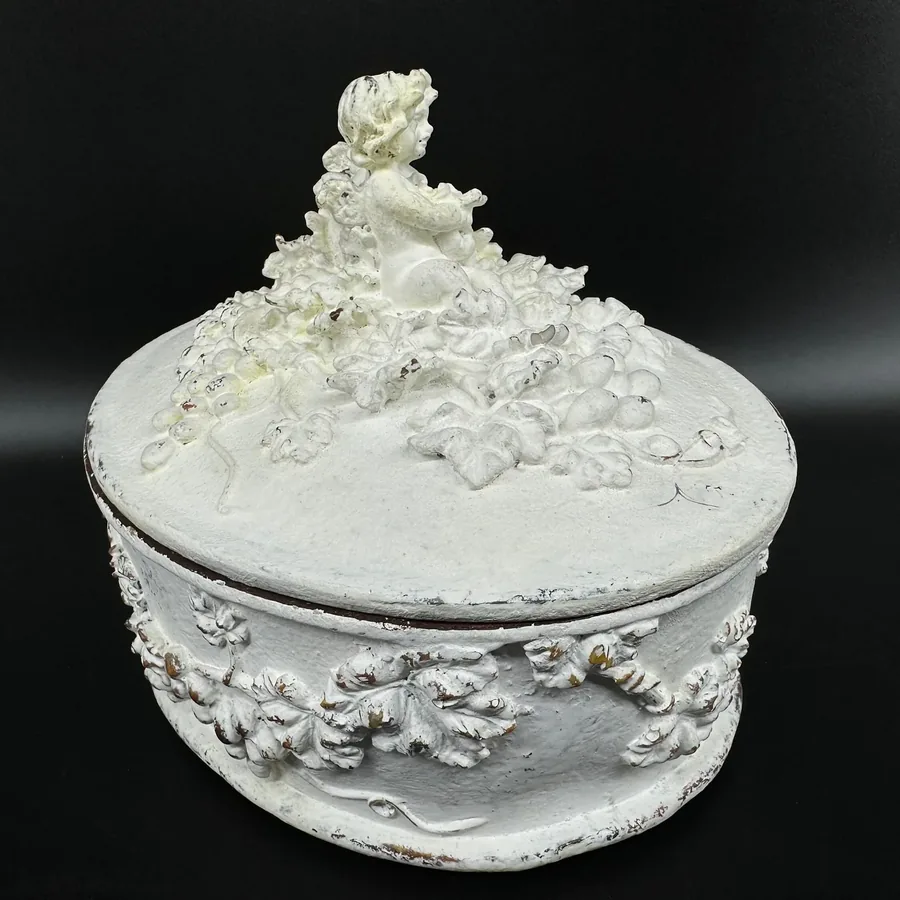 Hand-painted white Rococo jewelry box with cherub finial and textured relief carving, side-angled view