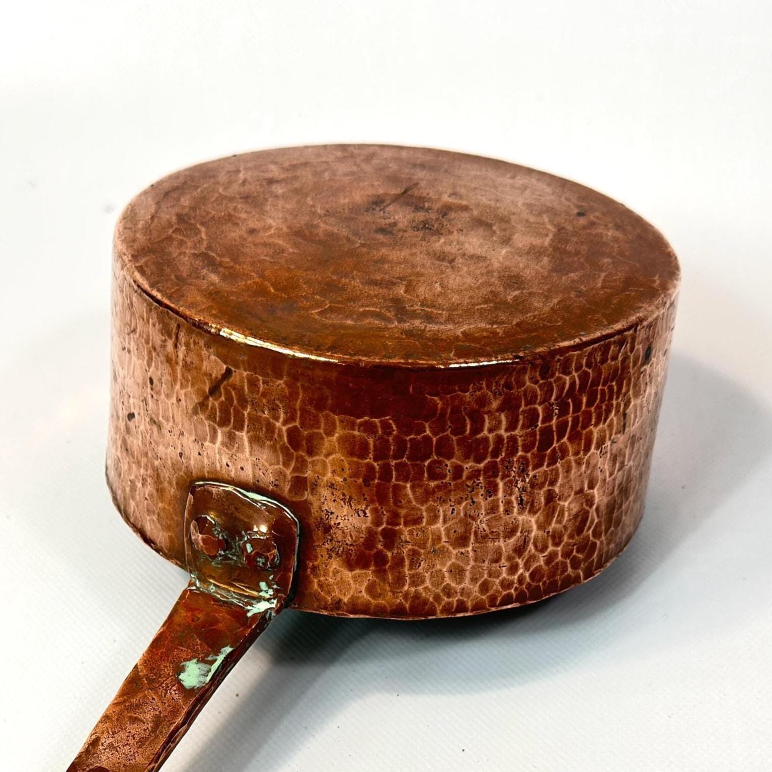 Handle grip area emphasizing ergonomic design and decorative iron work detail of vintage Scandinavian copper saucepan