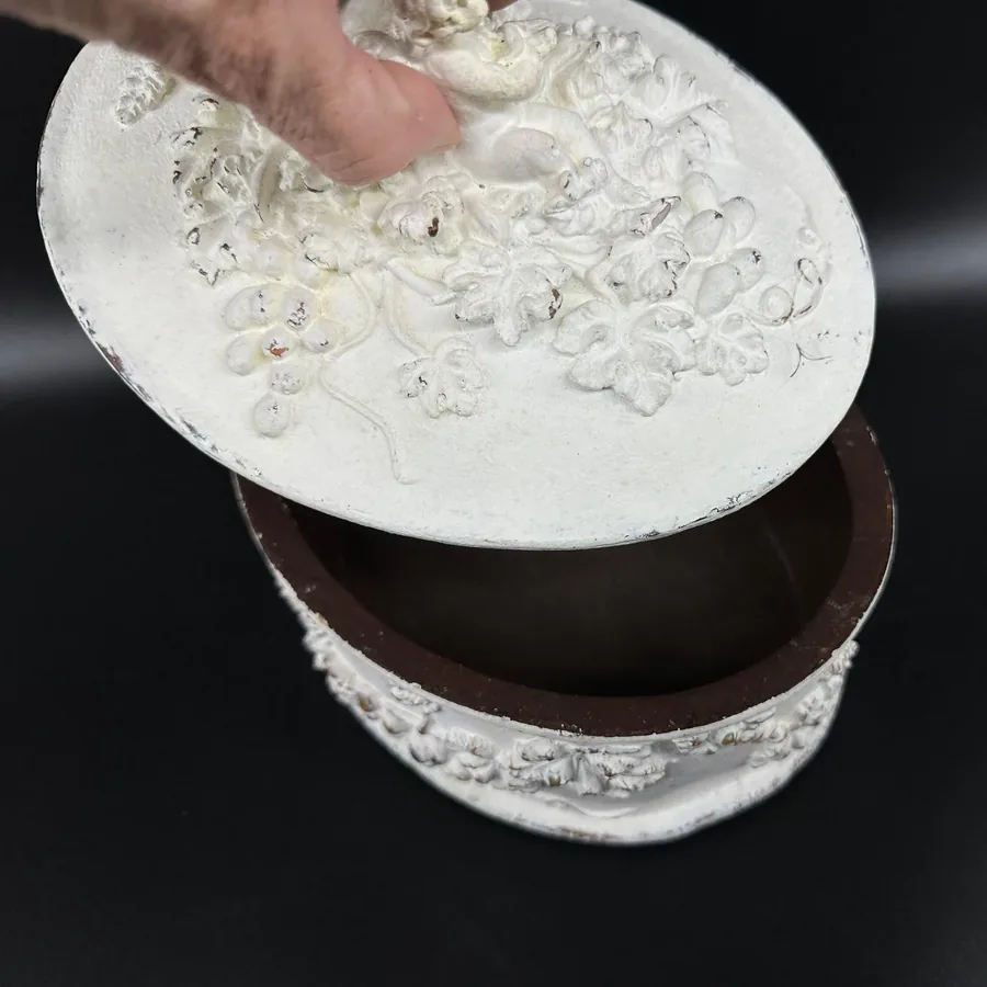 Interior view of white wooden box showing lid underside with hand-painted surface and velvet lining detail