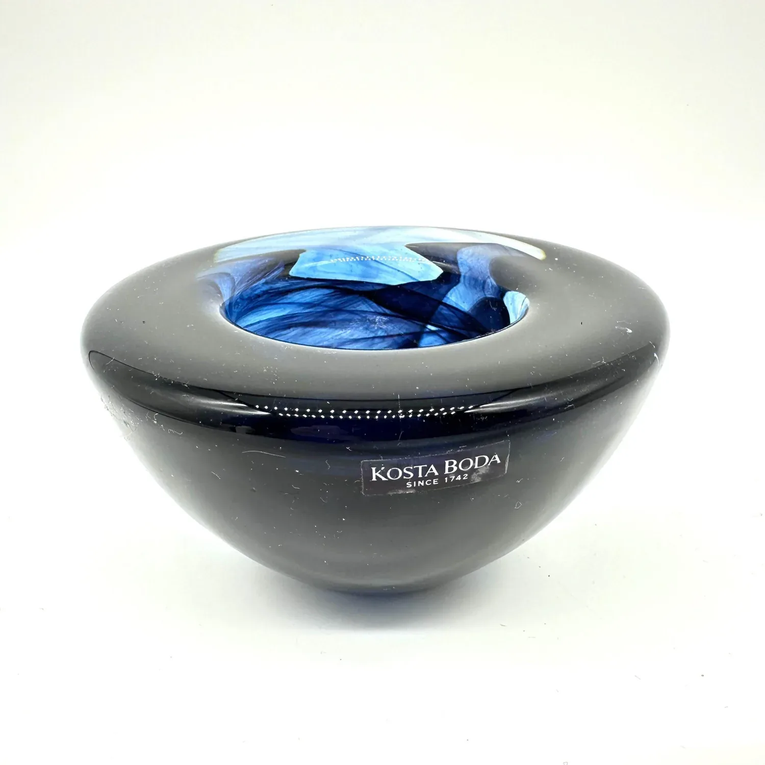 Kosta Boda Atoll bowl, charcoal gray ceramic with cobalt blue swirl glass interior, Swedish 1990s design