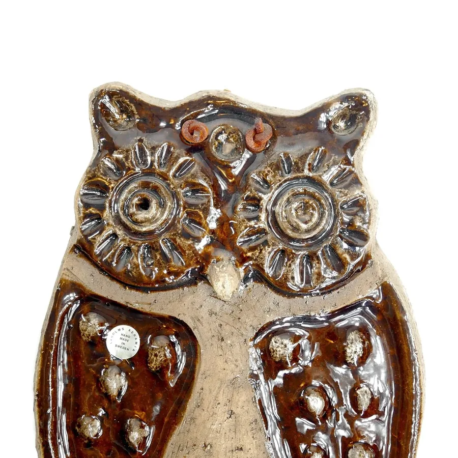Laholm ceramic owl straight-on view showing symmetrical design, detailed wing relief, warm brown finish, mounting hardware