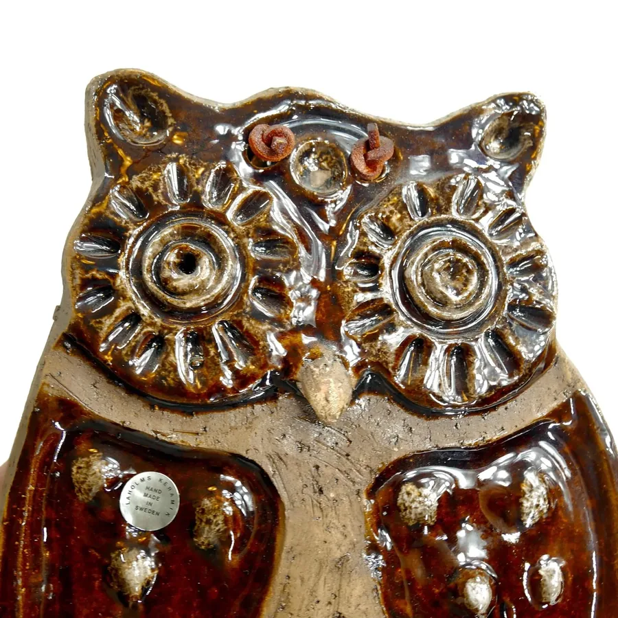 Laholm owl plaque close-up of molded features showing textured brown wings, carved facial details, cream ceramic surface