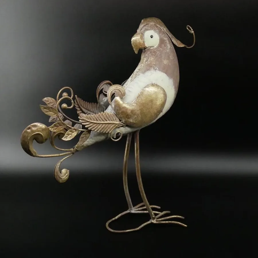Metal parrot sculpture front-facing view with upturned beak and decorative tail feathers spread in graceful arcs