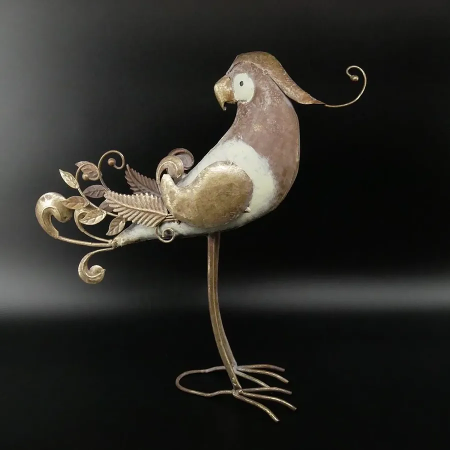 Metal parrot shown at slight angle with tail feathers flowing upward, highlighting sculptural form and metallic sheen