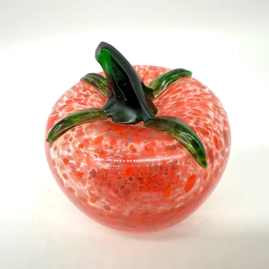 Overhead angle of red glass tomato displaying stem placement and full speckled body surface
