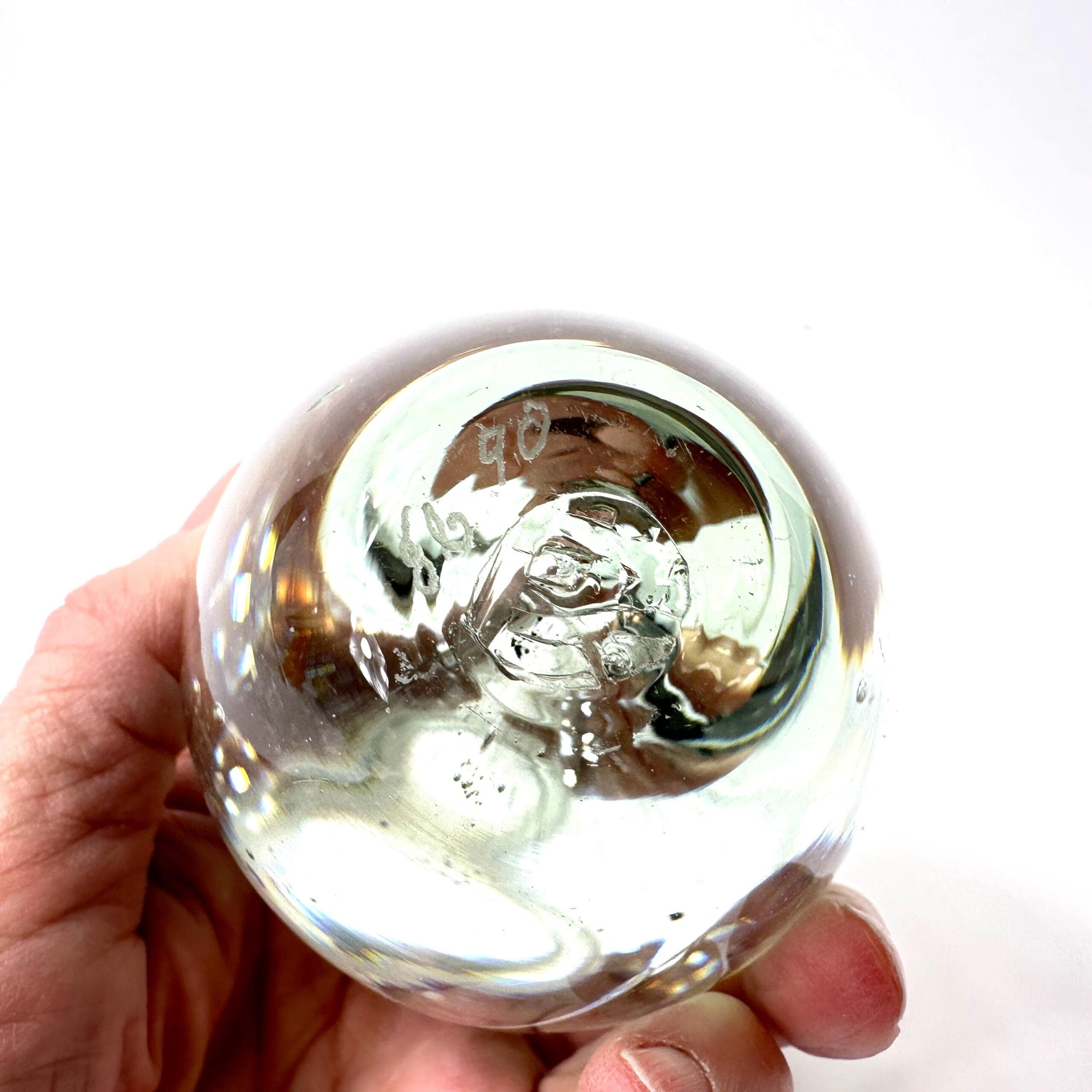Perfume bottle held in hand showing scale, weight, and tactile surface texture
