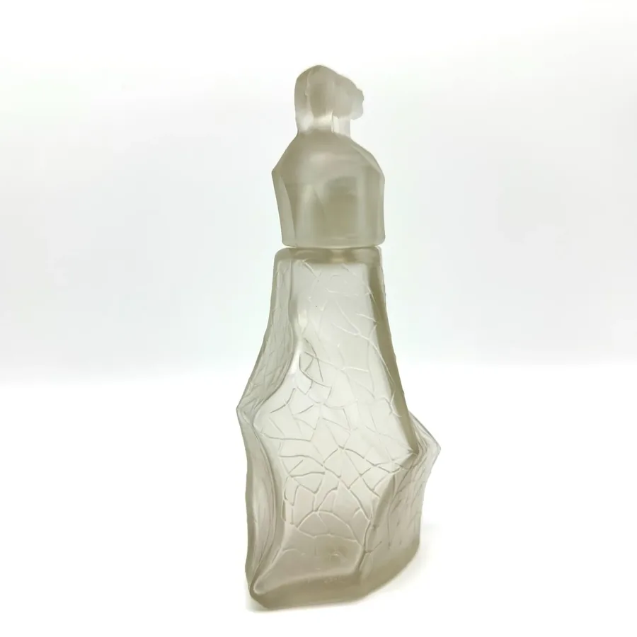 Reverse angle view of vintage 1930s TeZHe polar bear perfume bottle displaying back profile and glass transparency variations