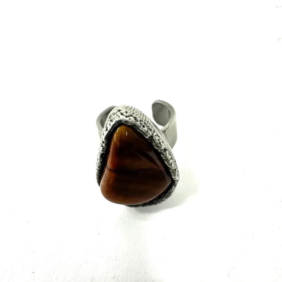 Ring worn on finger showing proportions, chunky statement design with golden-brown Tiger's Eye centerpiece