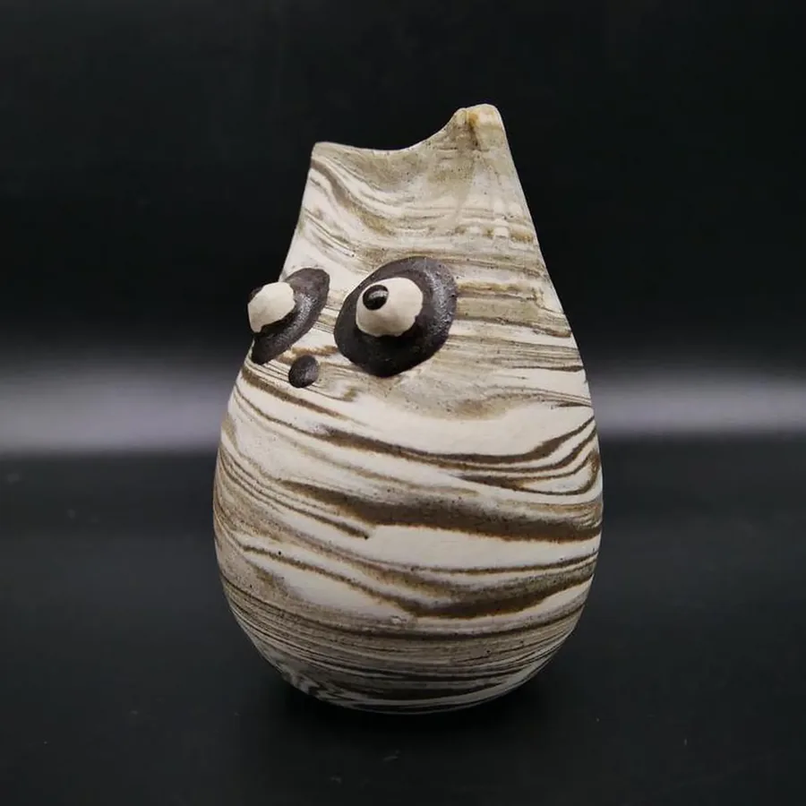 Signed Scandinavian pottery owl with cream and brown marbled clay, expressive black eyes and nose detail, handcrafted ceramic