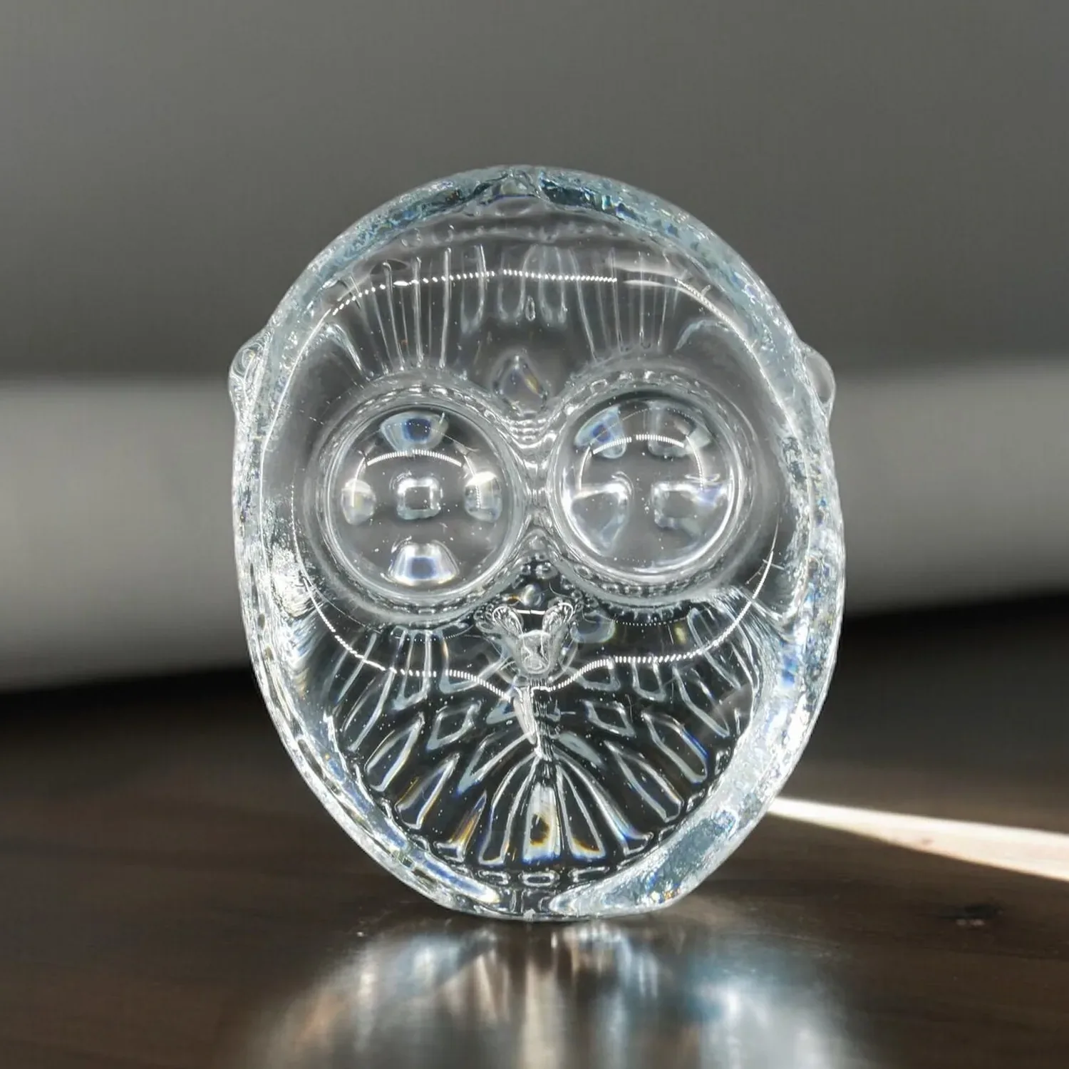 Swedish crystal owl sculpture with detailed facial features and radiant wings, front view showcasing translucent glass artist