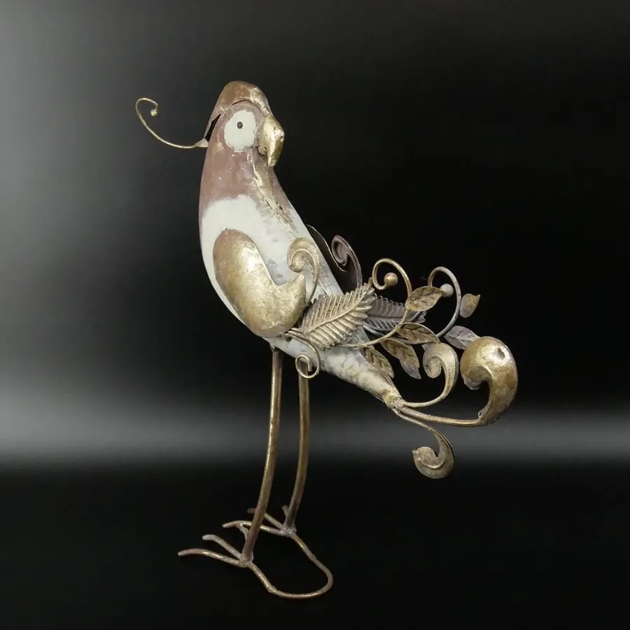 Tall metal parrot showing full ornamental tail feathers with curved flourishes and proud standing posture