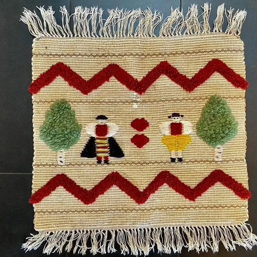 Vintage 1970s handwoven wool tapestry with Flemish folk costume scene, earth tones, traditional textile art