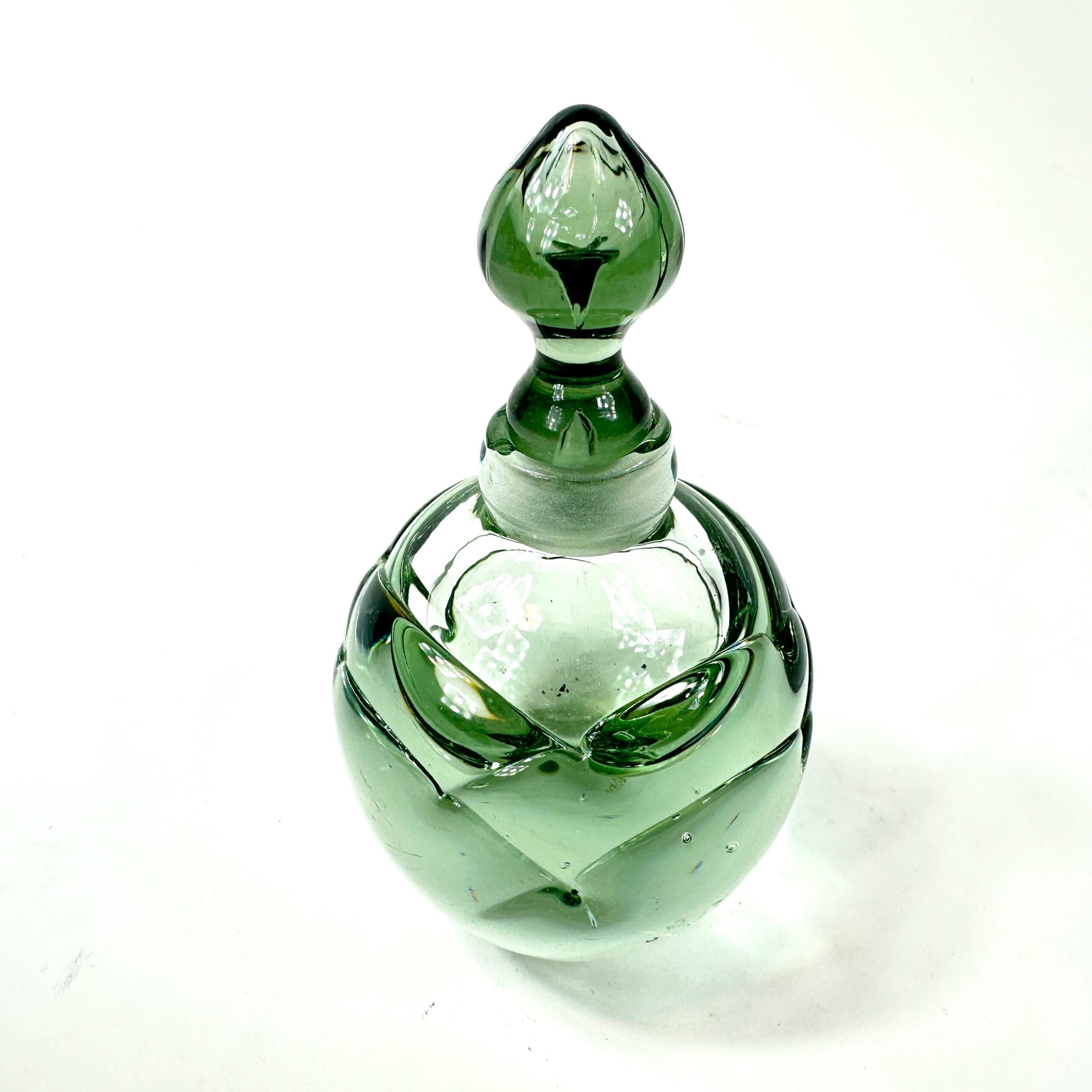 Vintage green glass perfume bottle top detail showing stopper and rim craftsmanship
