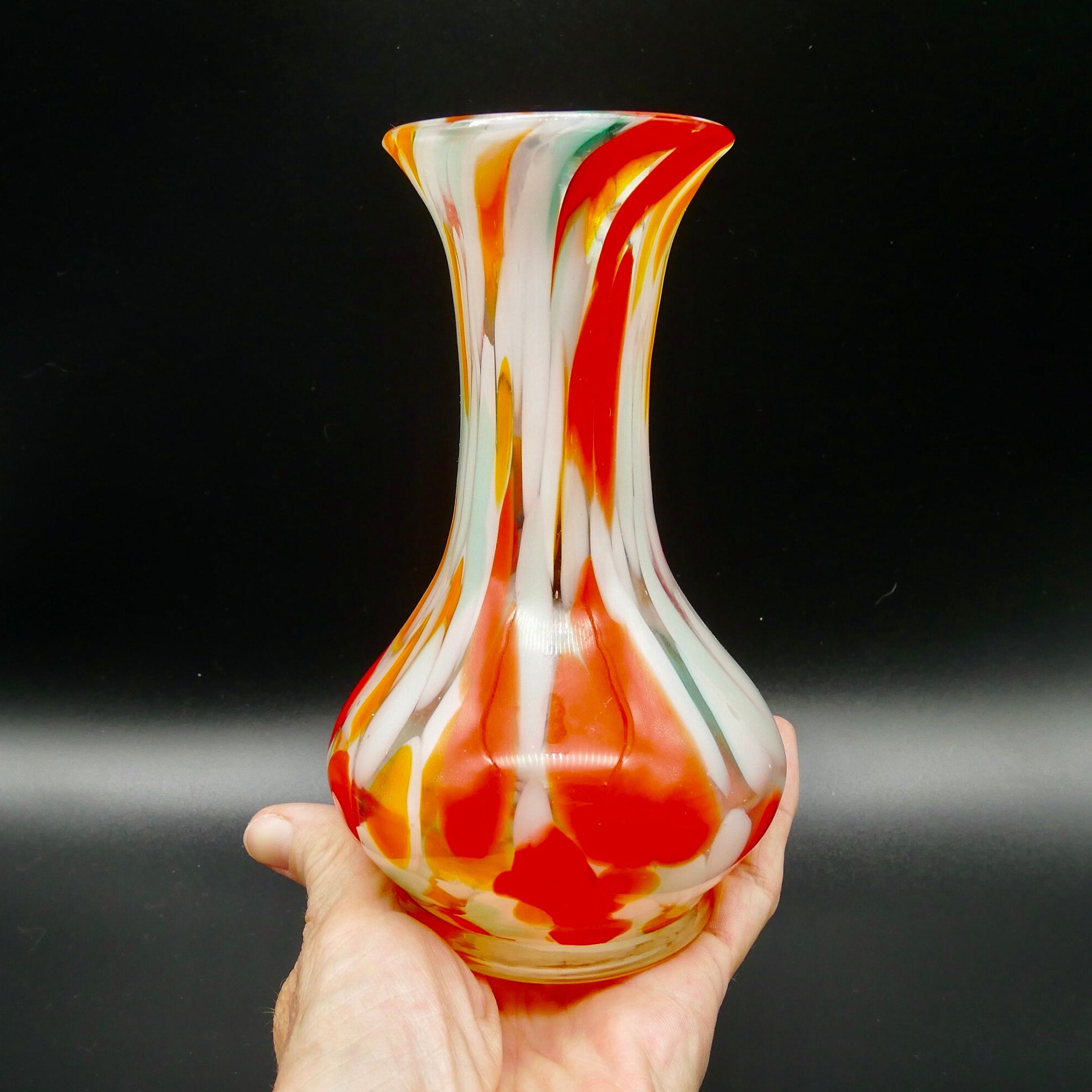 Vintage Hovmantorp Glasbruk Puttaglas vase held in hand, red orange and white swirled glass 1970s Swedish