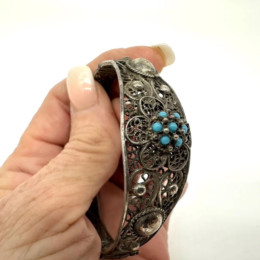 Vintage silver filigree cuff bracelet with turquoise beads and tribal-inspired ornate metalwork detail