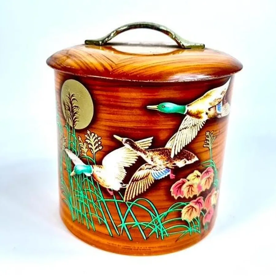 Vintage tin woodgrain finish texture showing realistic faux wood lithography from 1940s