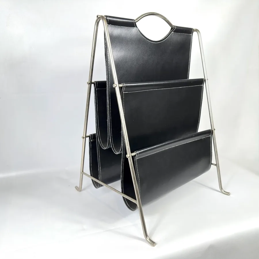 1960s Bauhaus magazine rack with black leatherette shelves and polished chrome tubular frame, three-tier design with circular