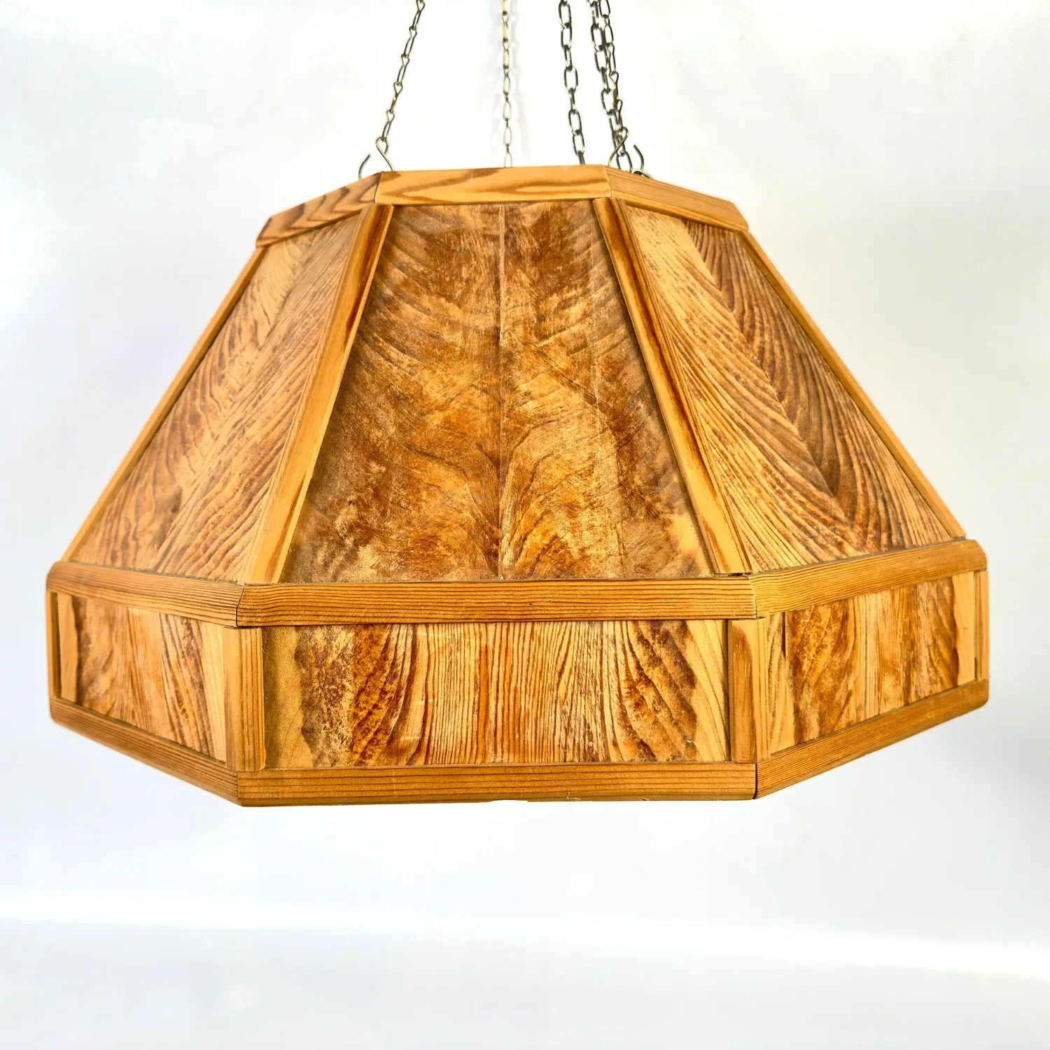 1970s Scandinavian pine pendant light with geometric hexagonal design, warm honey-toned wood grain, suspended by silver chain