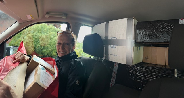 Amanda Granlund, founder of All Things Retro, inside a vintage-filled van surrounded by carefully curated antique pieces and