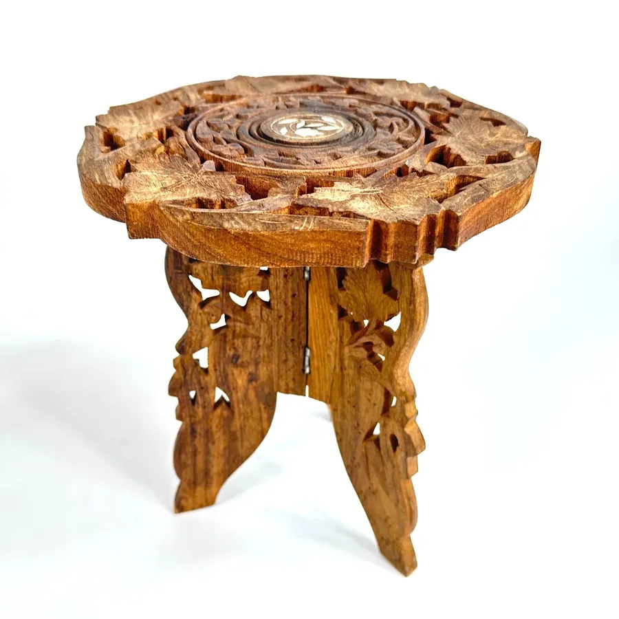 Angled view of complete wooden plant stand showing all three folding legs and full carved top surface