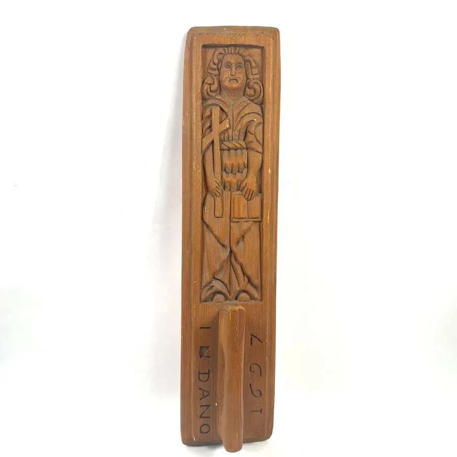 Antique Norwegian mangling board dated 1697, carved wood with standing figure holding staff, worn handle visible