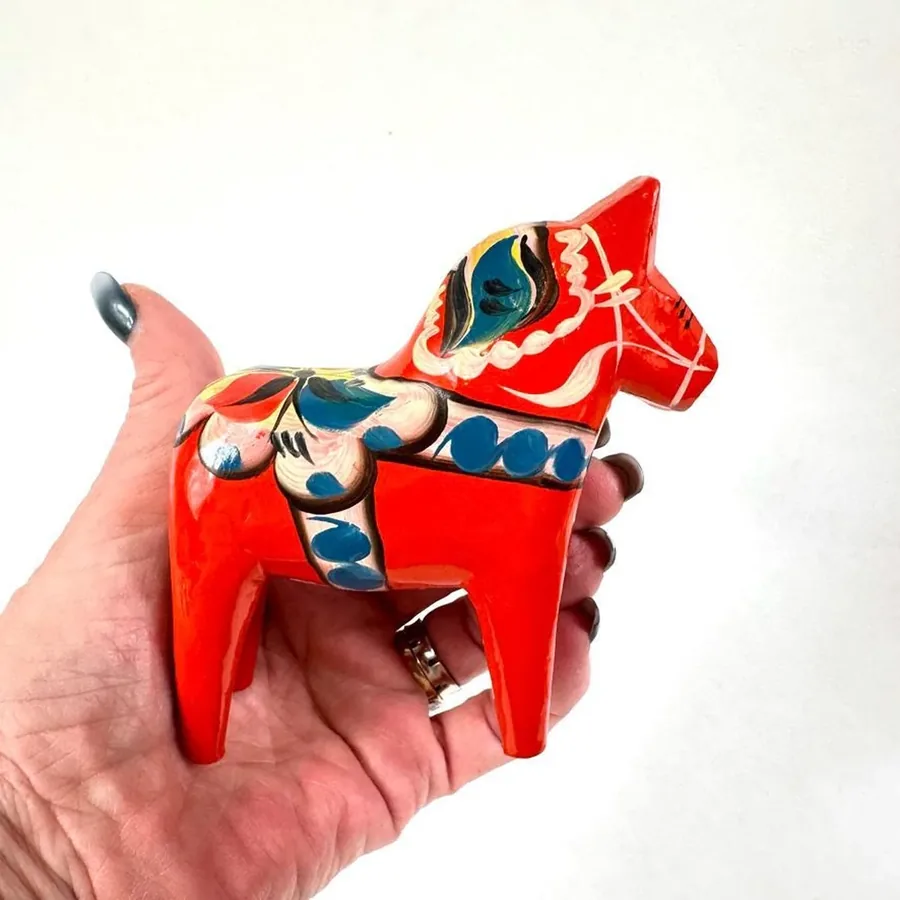 Dala horse miniature in palm, displaying complete hand-painted pattern, vintage wooden construction with folk art detail