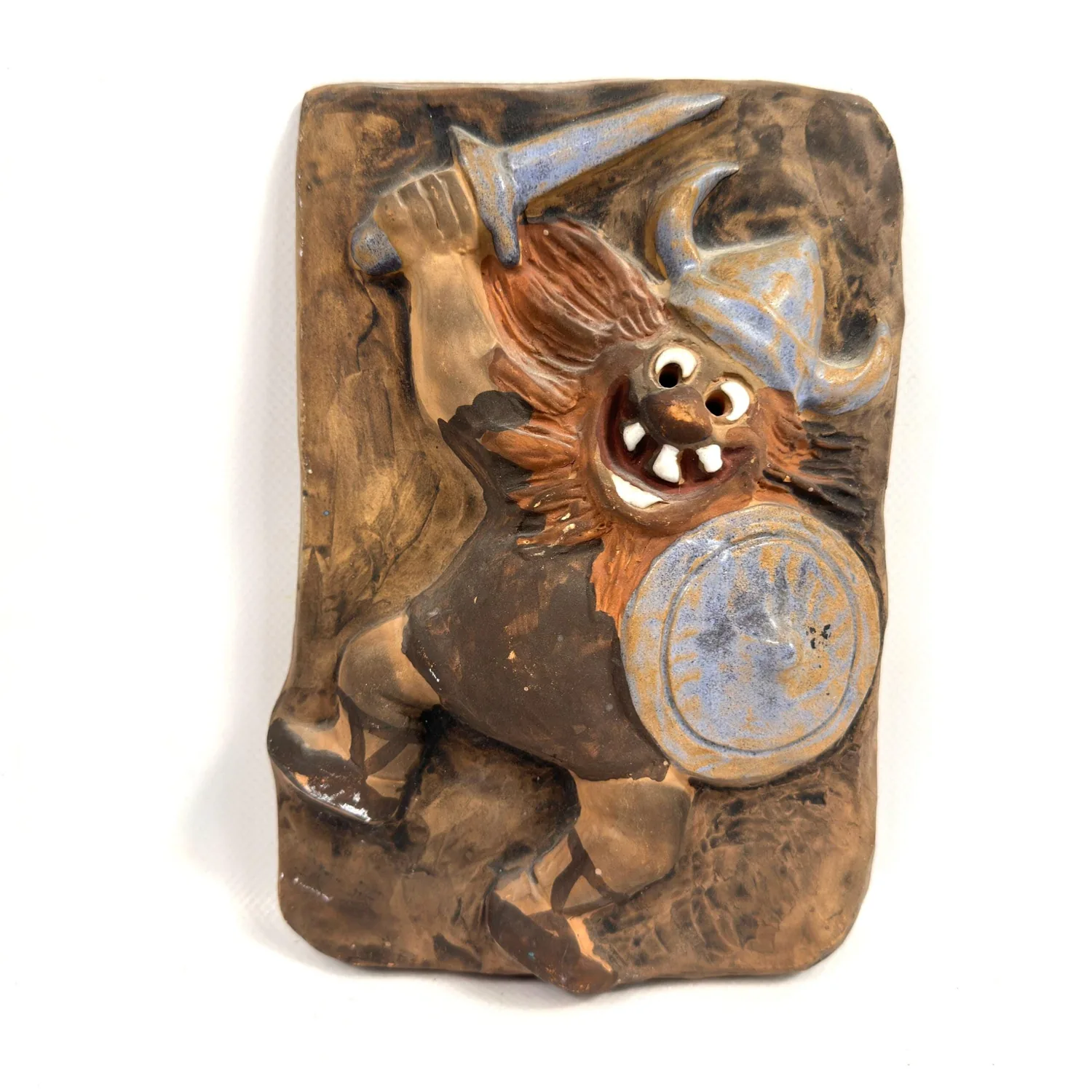Danish ceramic troll wall tile from 1965 with hand-carved relief warrior figure, brown glazed body, blue-grey shield and swor