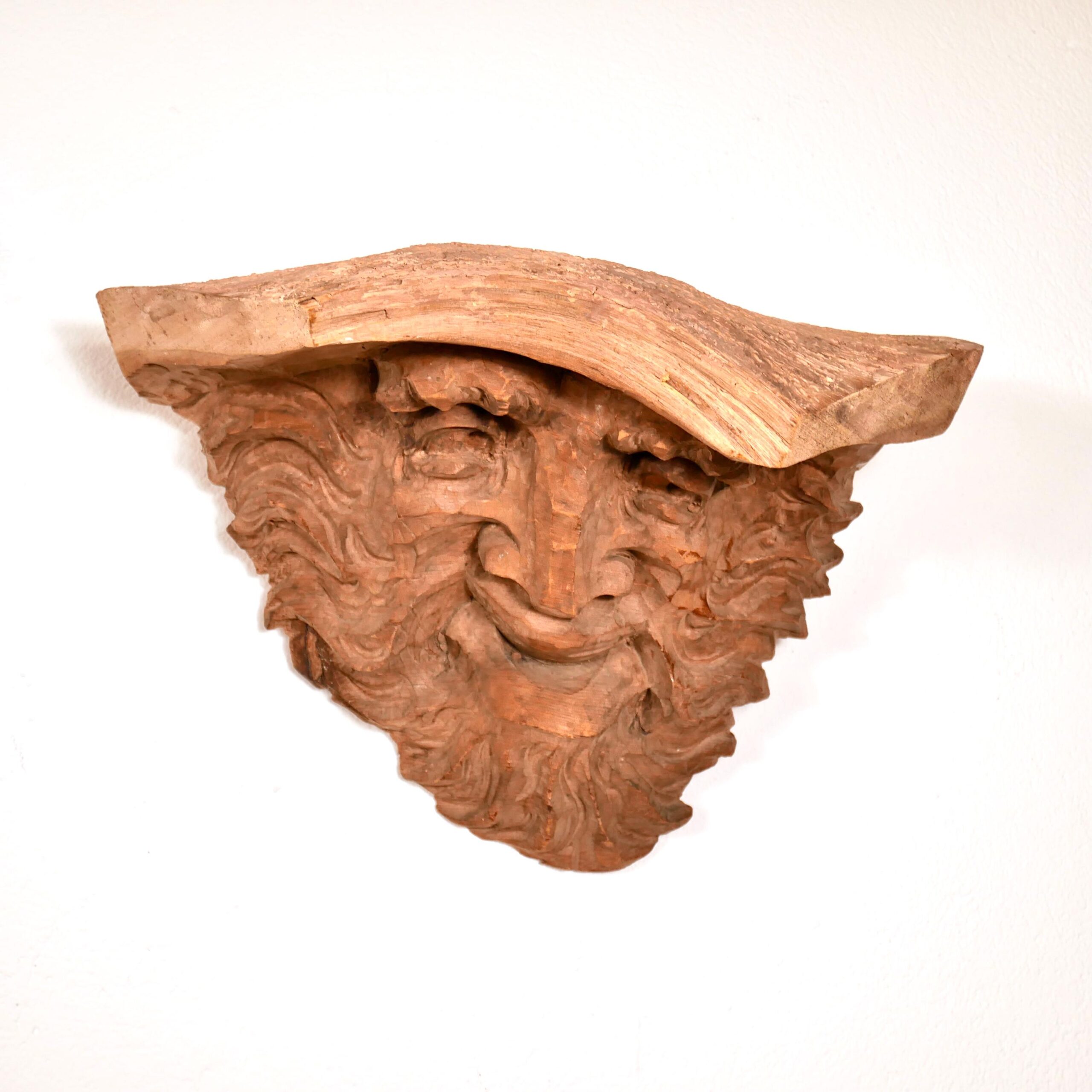 Detailed view of carved beard texture showing individual strand work and weathered wood patina characteristic of age