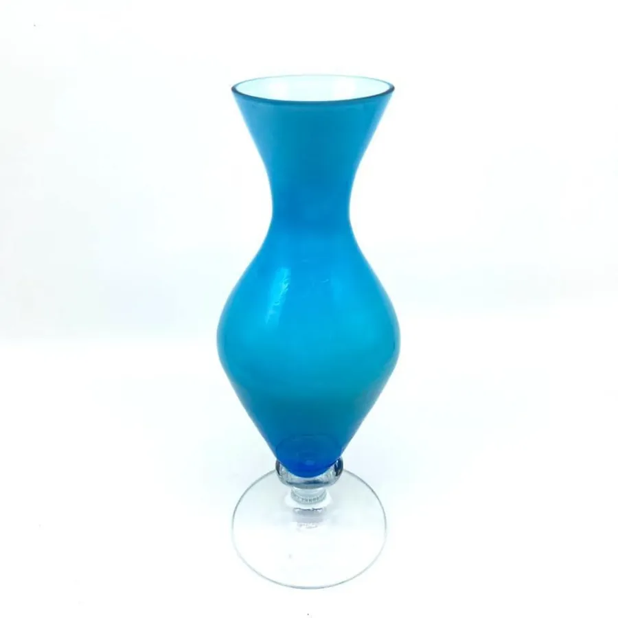 Final studio view of complete vase emphasizing elegant silhouette, pedestal base support, luminous blue finish, and display r