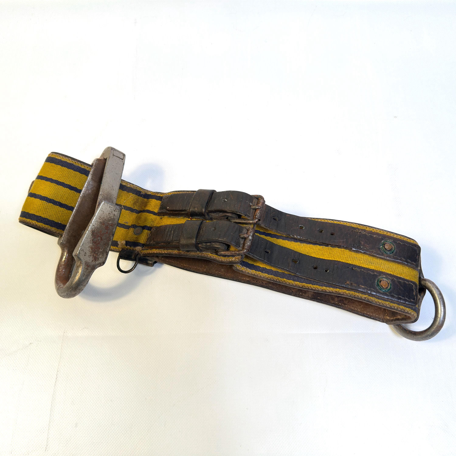 Flat lay of vintage military belt showing full striped canvas and webbing pattern with buckle assembly