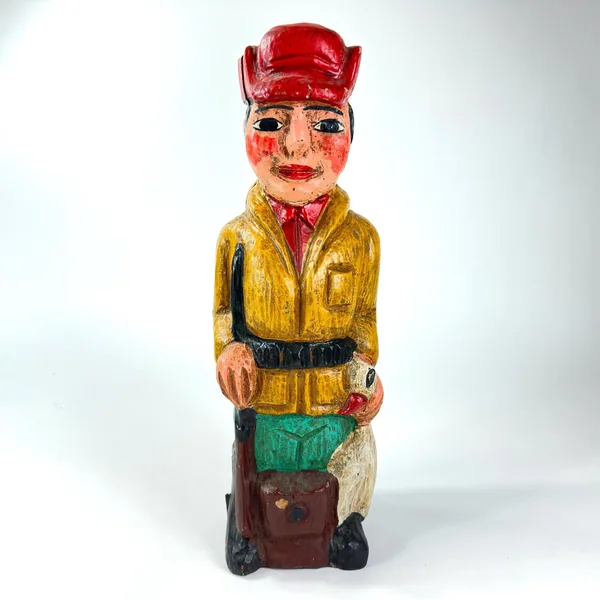 Front perspective of 1940s carved wood bottle case with red-capped huntsman figure and traditional fox hunt carving design