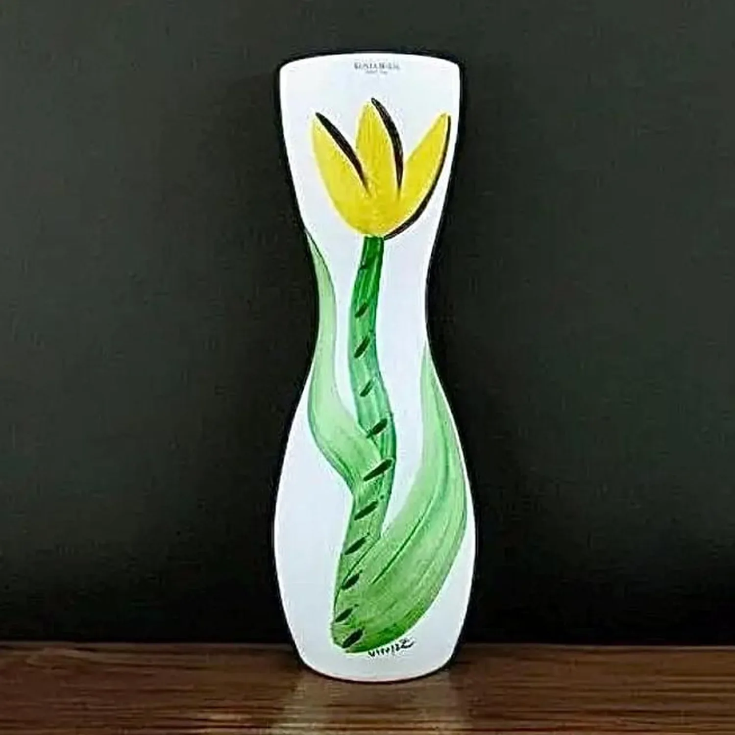 Kosta Boda hourglass vase with hand-painted yellow tulip and green stem on white stained glass, front view