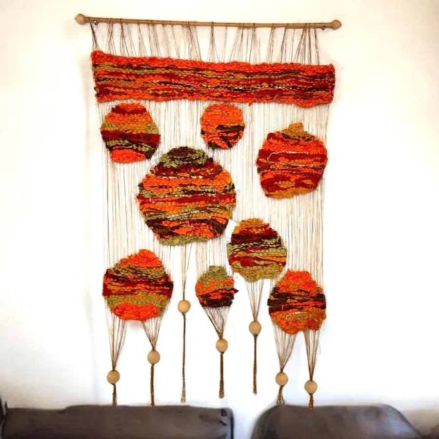 Large vintage Swedish wall tapestry from 1960s with orange-red geometric circles, natural wood beads, cream fringe, and woven
