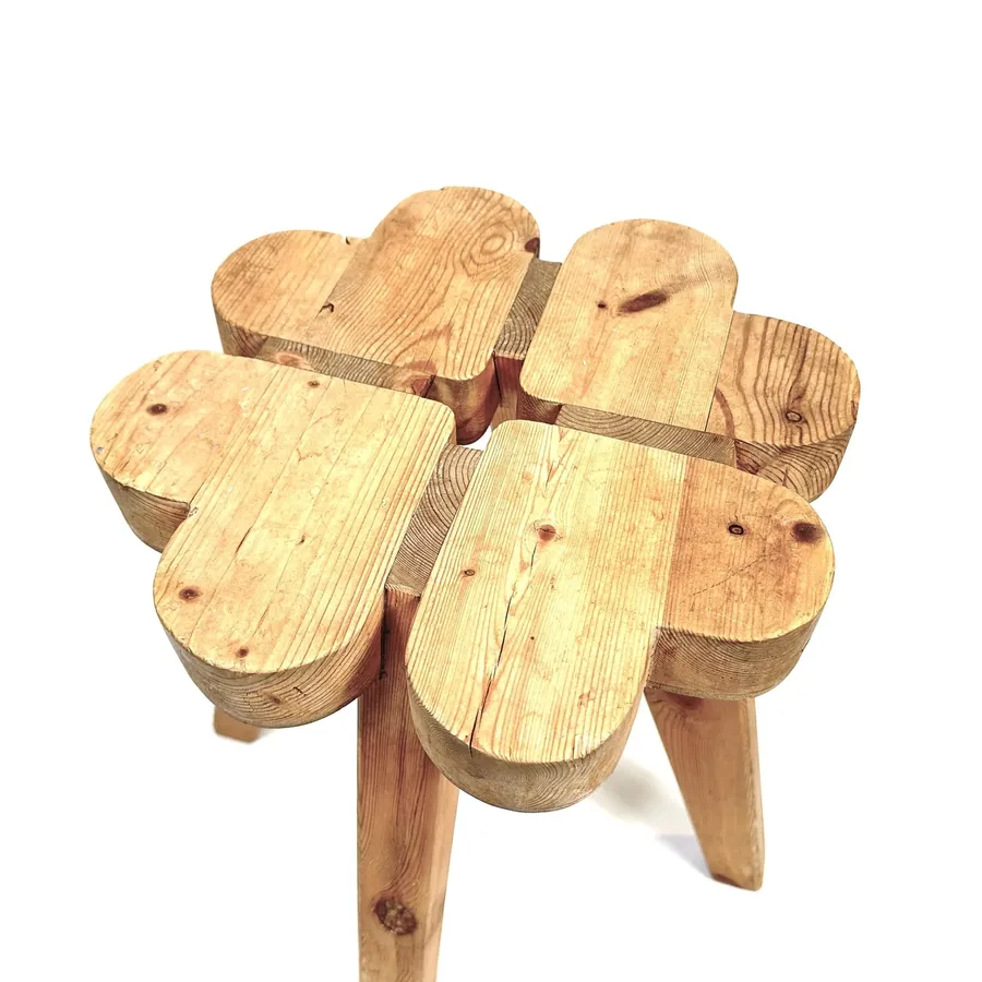 Overhead angle showing six individual wooden seat blocks fitted together in clover pattern with visible grain texture