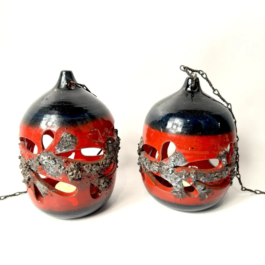 Pair of 1970s Icelandic lava-glaze ceramic hanging lanterns in red and black with organic cutout openings and volcanic textur