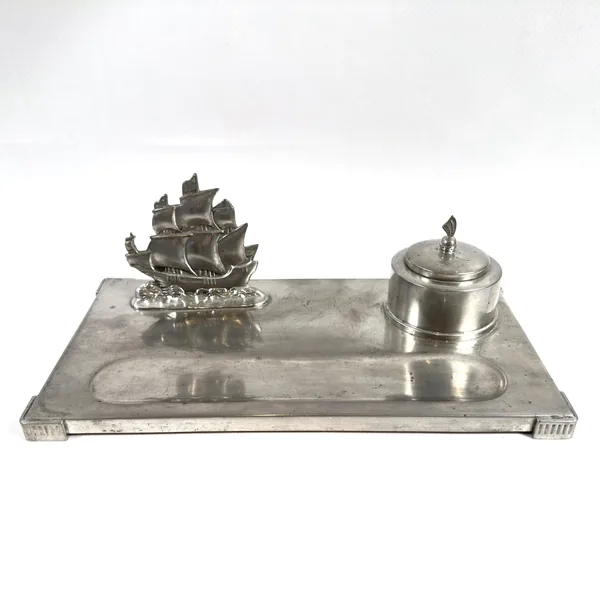 Pewter desk set from above showing ship figurine and ink vessel on rectangular platform with patina finish