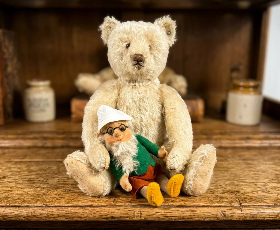Vintage Steiff teddy bear seated beside a small handpainted folk toy on wooden surface