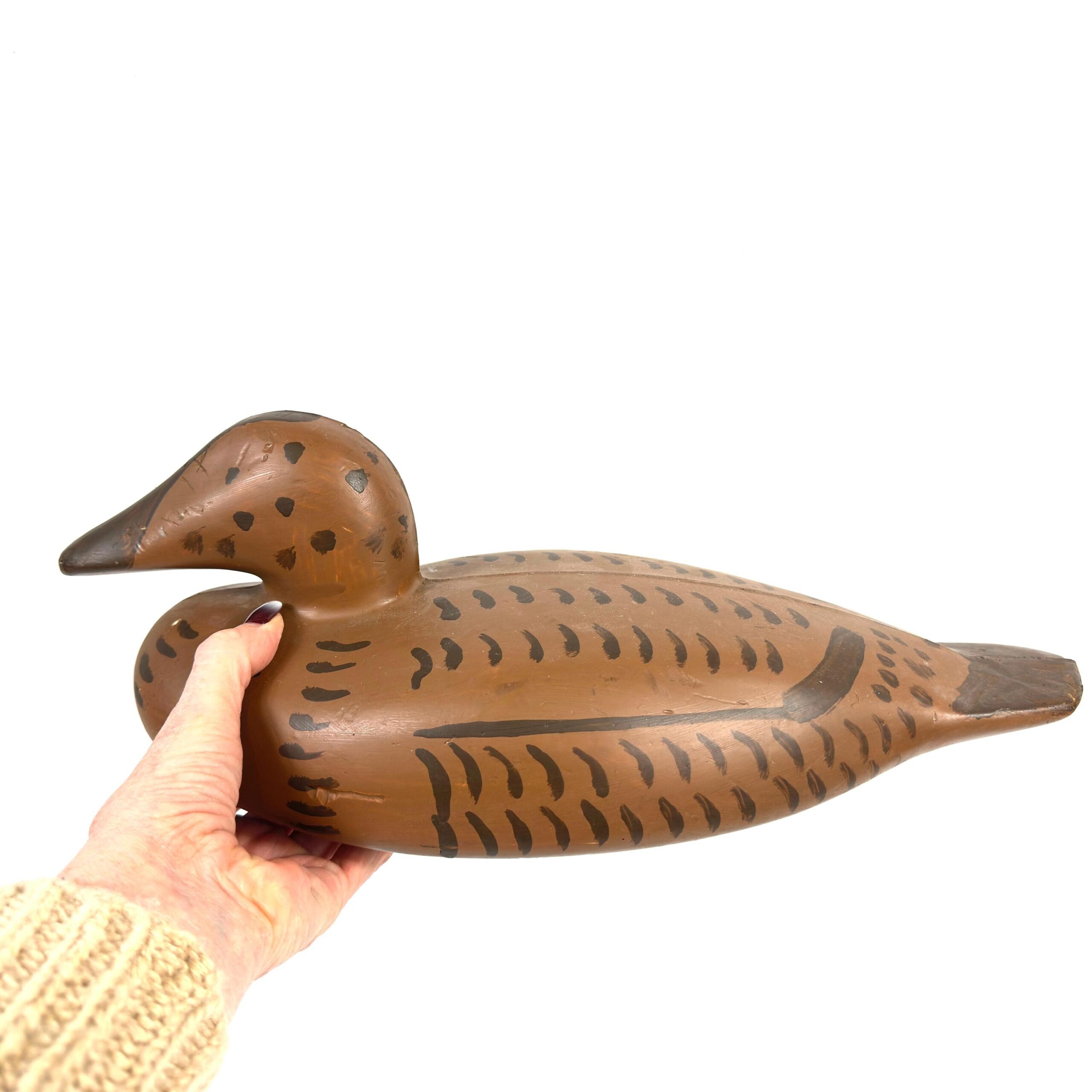 Vintage 1960s mallard duck decoy in hand, showing hand-painted feather details and weighted construction from front angle