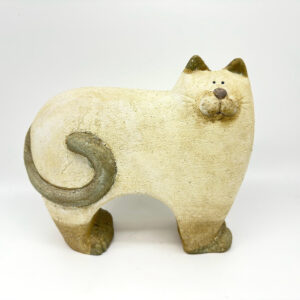 Cream glazed stoneware cat sculpture with curved tail and bronze accents, three-quarter view profile