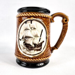 Vintage nautical ceramic stein with relief-carved tall ship and rope border detailing, brown glaze, 1980s
