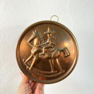 Vintage Swedish copper jelly mold with tin lining, featuring embossed folk art design of rider on rocking horse, complete wit